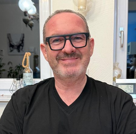 Claus Schertz, nahes persönliches Porträt mit Brille und offenem Lächeln